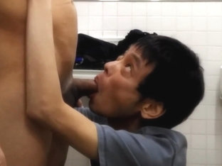 Japanese gay helping friend to cum in the public bathroom